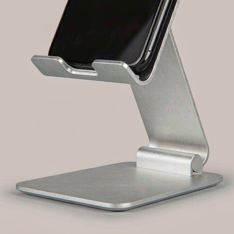 Delphi Phone Stand, silver aluminum with a phone resting on it